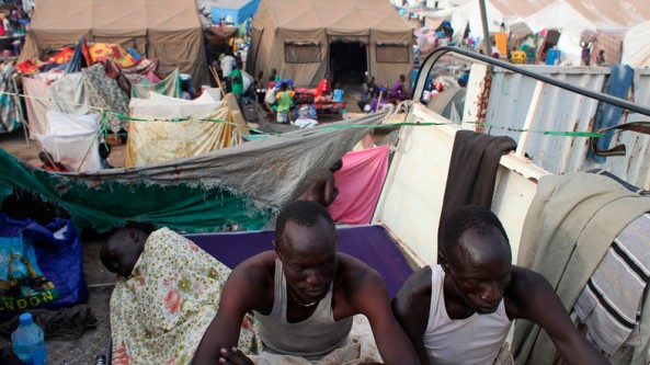Displaced men rest in an improvised shelter at Tomping camp, where some 17,000 displaced people are being sheltered by the UN, in Juba