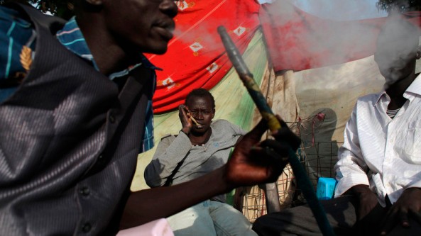 Displaced men smoke shisha at Tomping camp, where some 17,000 displaced people are being sheltered by the UN, in Juba